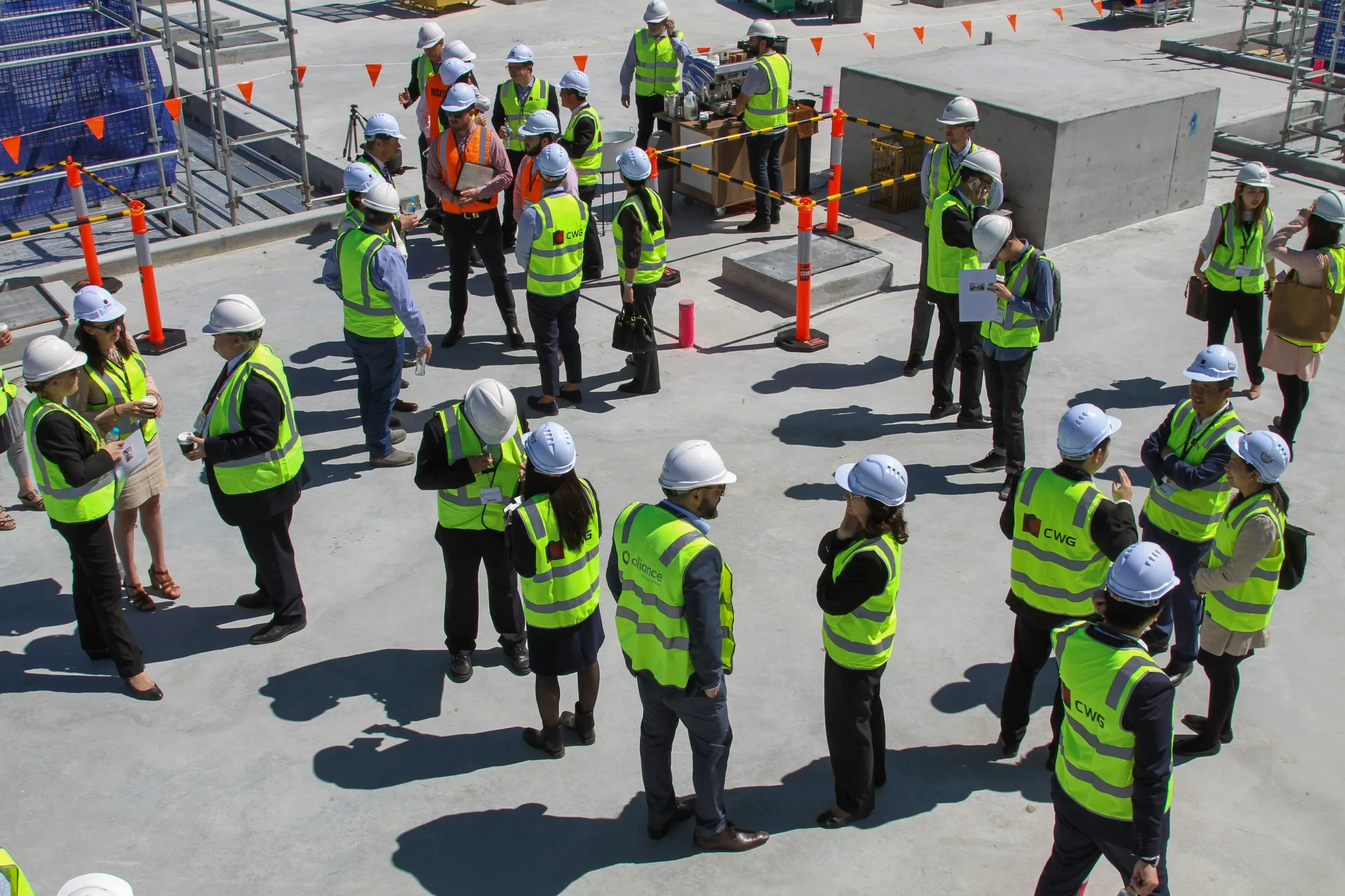 A site team in hard hats and high-visibility vests gathered for a briefing